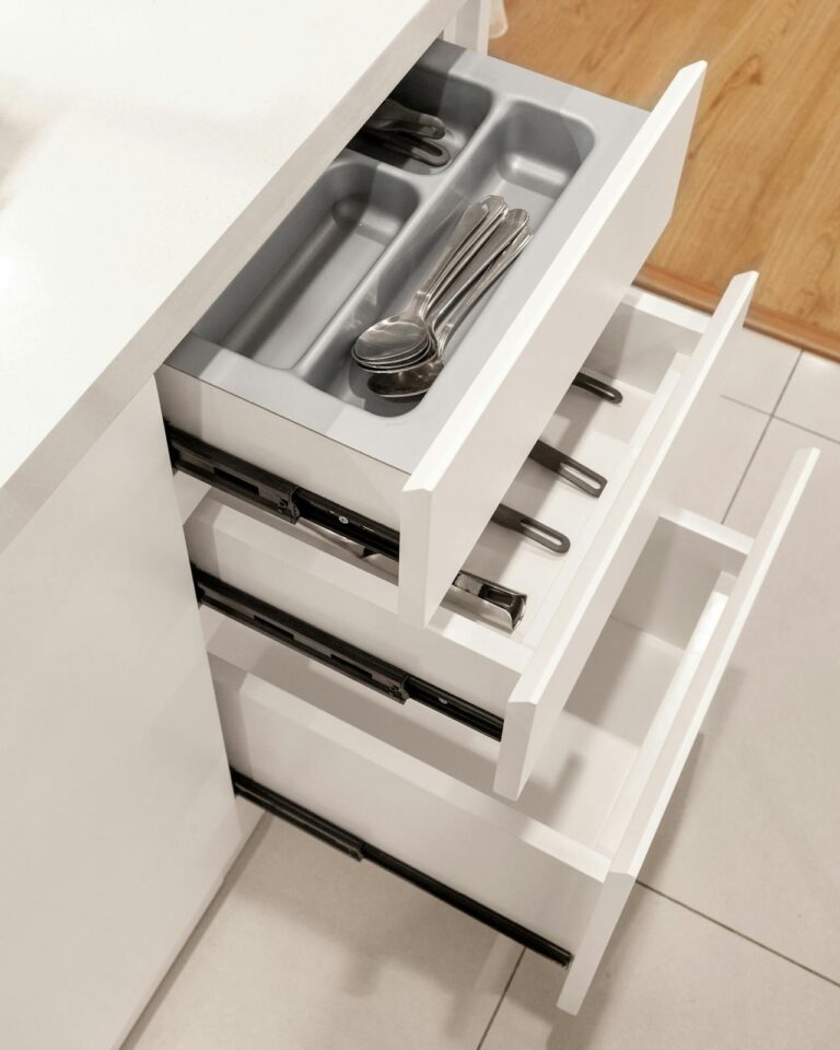 Organized deep kitchen drawer with dividers and neatly grouped items.